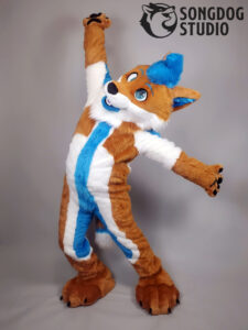 Orange and blue toony fox fursuit posing with wide arms